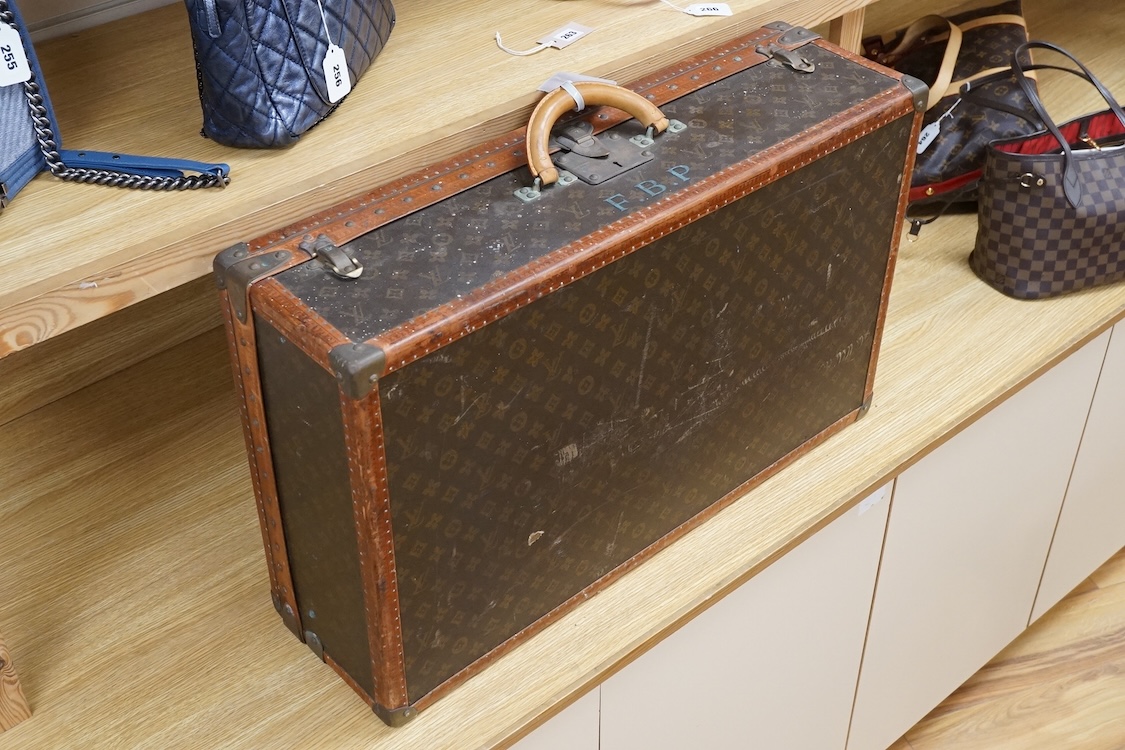A vintage Louis Vuitton monogram suitcase with two original keys, numbered 793692 to the linen covered interior, height 22cm, width 76cm, depth 46cm